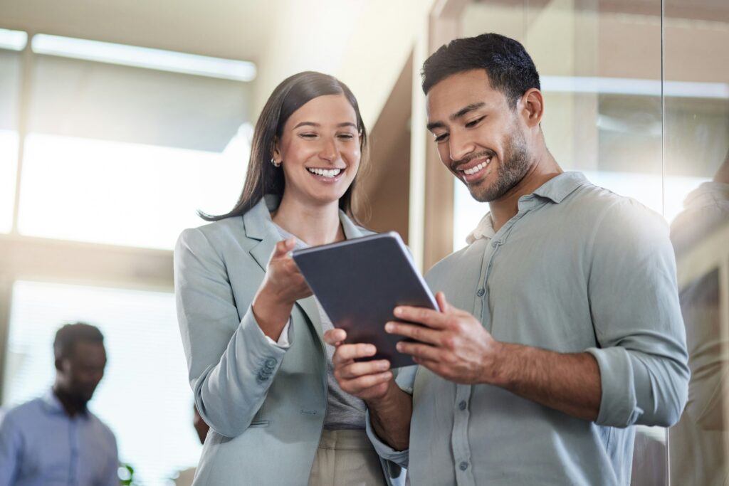 im so glad i found you shot of two coworkers talking while using a digital tablet Dataforall